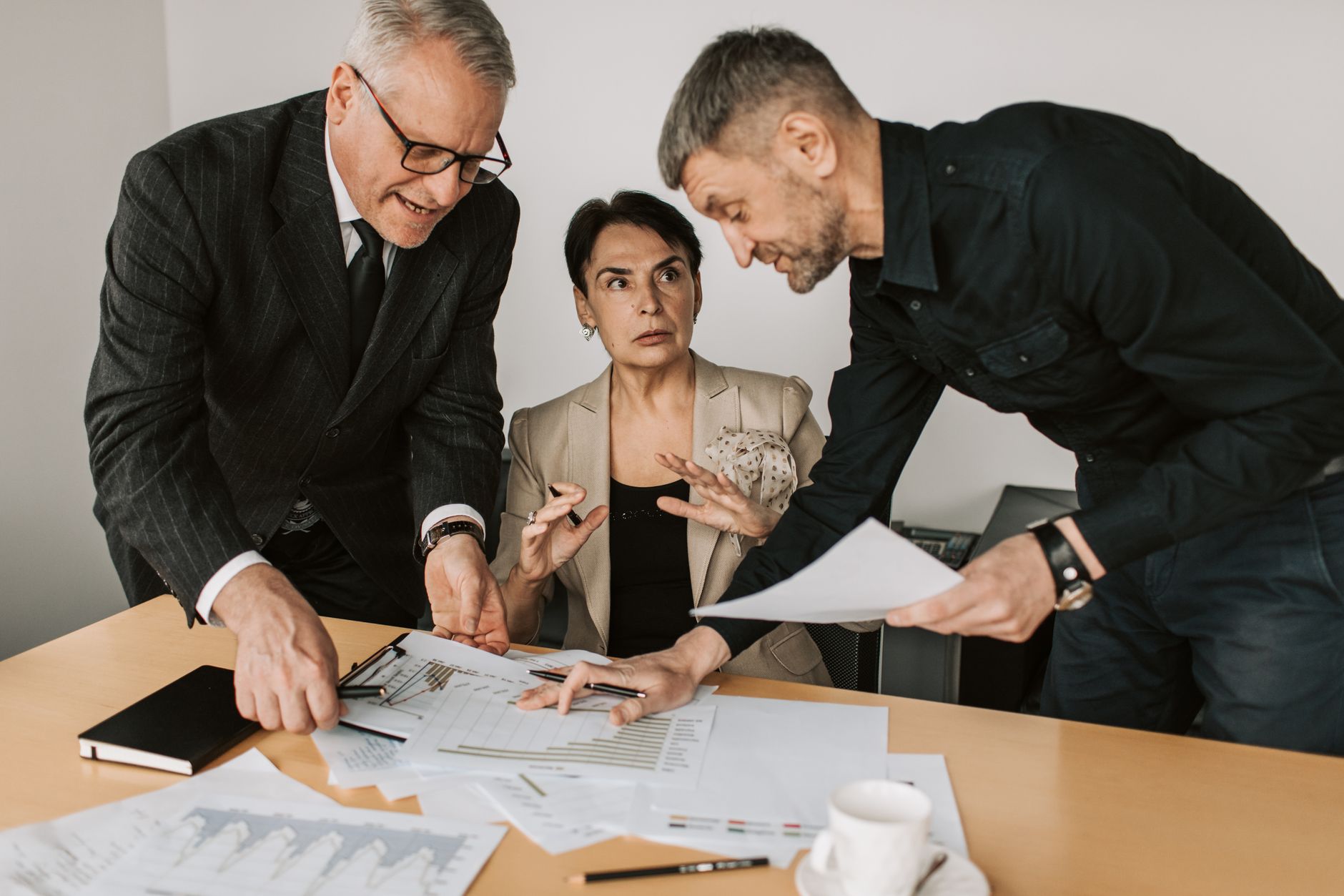 Three people reviewing papers